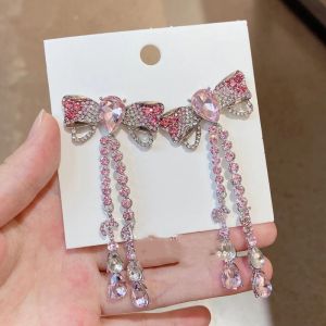 EUR095-1 large bow details crystal long earrings in baby Pink