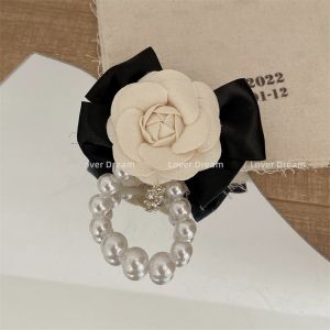 1550 Camelia flower with Black bow and No 5 brooch in Cream