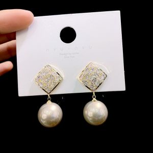 EUR175 Crystals earrings with pearl drop in Champagne