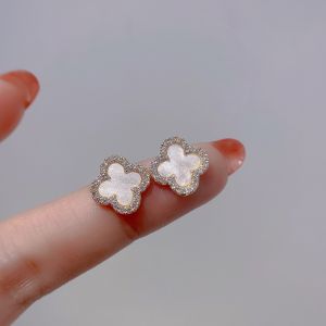 EUR290 diamante edge petal earrings in Cream